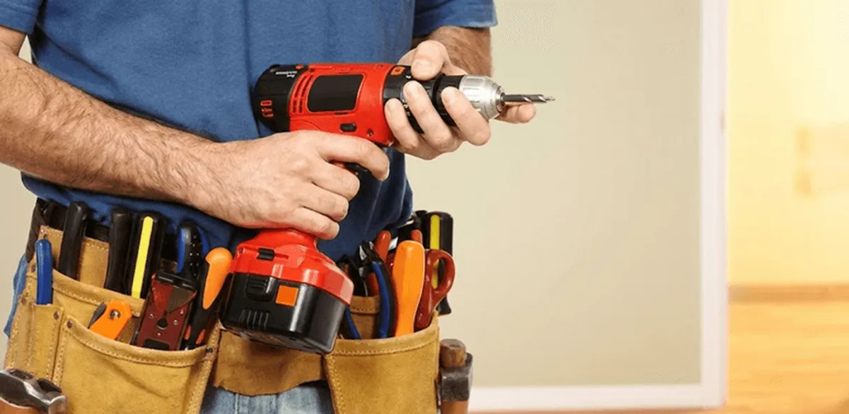 Handyman holding a power drill for home repairs and installations in Little Rock, AR